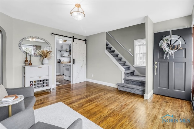 3122 Winston Blvd, Toledo, OH 43614 - entryway featuring stairs, healthy amount of natural light, wood finished floors, and a barn door