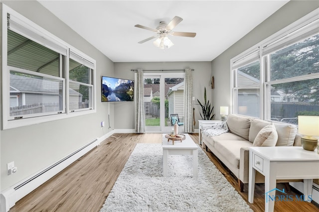 3122 Winston Blvd, Toledo, OH 43614 - living room with a baseboard radiator, wood finished floors, and a ceiling fan
