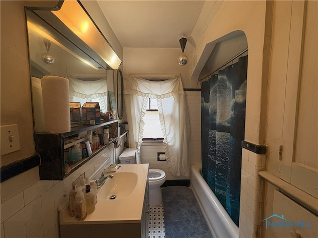 1336 Craigwood Rd, Toledo, OH 43612 - full bath featuring vanity, shower / bath combo with shower curtain, and tile walls