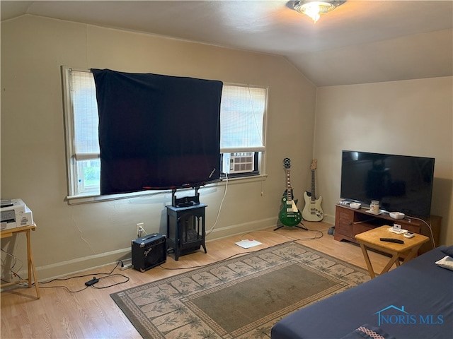 1336 Craigwood Rd, Toledo, OH 43612 - living room featuring vaulted ceiling, wood finished floors, healthy amount of natural light, and cooling unit