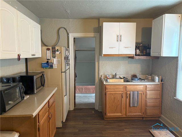 1336 Craigwood Rd, Toledo, OH 43612 - kitchen featuring a textured wall, dark wood-style flooring, stainless steel microwave, light countertops, and black microwave