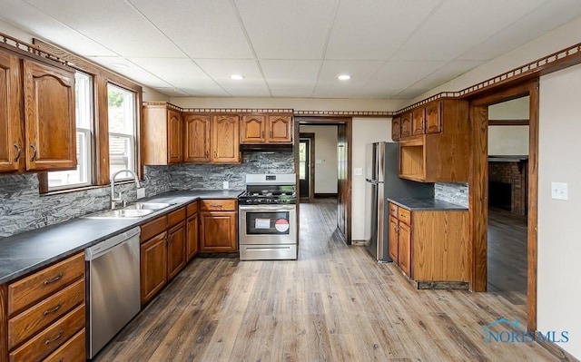 1553 Flormar Ct, Toledo, OH 43612 - kitchen with stainless steel appliances, under cabinet range hood, brown cabinets, light wood finished floors, and recessed lighting