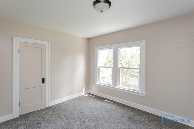 1553 Flormar Ct, Toledo, OH 43612 - spare room with dark colored carpet and baseboards