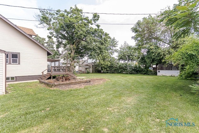 1553 Flormar Ct, Toledo, OH 43612 - view of grassy yard featuring stairs and a wooden deck