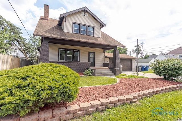 1553 Flormar Ct, Toledo, OH 43612 - view of front of house featuring a porch, a chimney, brick siding, and a shingled roof