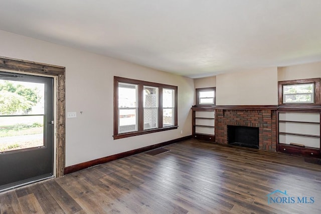 1553 Flormar Ct, Toledo, OH 43612 - unfurnished living room featuring wood finished floors and a brick fireplace