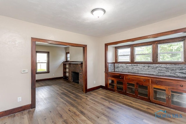 1553 Flormar Ct, Toledo, OH 43612 - unfurnished living room with plenty of natural light, wood finished floors, and a fireplace