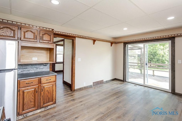 1553 Flormar Ct, Toledo, OH 43612 - kitchen with freestanding refrigerator, light wood-type flooring, backsplash, recessed lighting, and a paneled ceiling