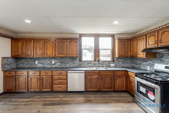 1553 Flormar Ct, Toledo, OH 43612 - kitchen with appliances with stainless steel finishes, under cabinet range hood, brown cabinets, a paneled ceiling, and recessed lighting