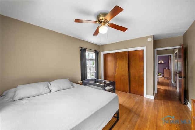 3740 Mapleway Dr, Toledo, OH 43614 - bedroom with light wood-style floors, a closet, and ceiling fan