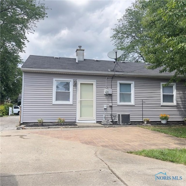 415 W Northgate Pkwy, Toledo, OH 43612 - rear view of property with a patio, a chimney, and a shingled roof