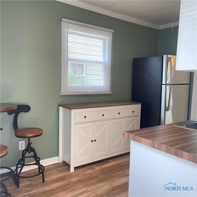 415 W Northgate Pkwy, Toledo, OH 43612 - kitchen featuring freestanding refrigerator, wood finished floors, white cabinets, crown molding, and butcher block countertops
