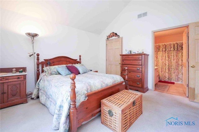 7673 Brookstone Dr Unit U7673, Findlay, OH 45840 - bedroom featuring light colored carpet, lofted ceiling, and ensuite bath
