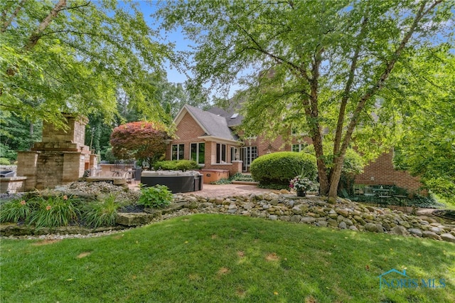 1616 Firestone Dr, Findlay, OH 45840 - view of green lawn featuring a jacuzzi and a patio