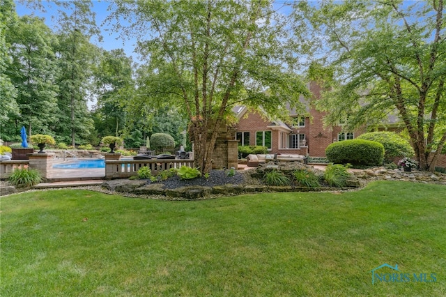 1616 Firestone Dr, Findlay, OH 45840 - view of grassy yard with an outdoor pool and a patio area