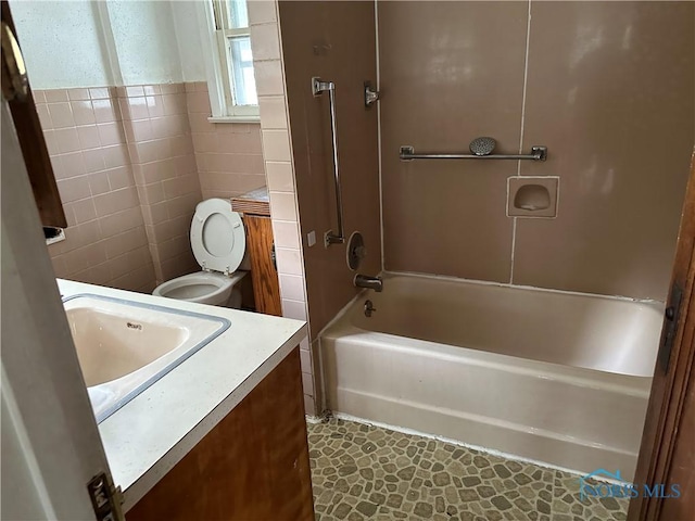 1623 W Central Ave, Toledo, OH 43606 - bathroom with vanity, shower / bath combination, tile walls, and wainscoting