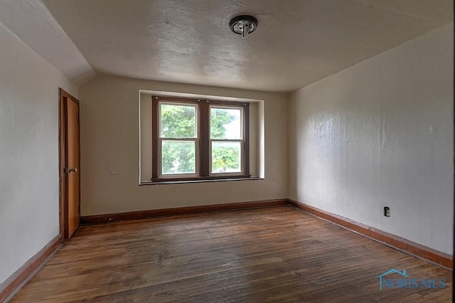 452 E Park St, Toledo, OH 43608 - spare room featuring wood finished floors and lofted ceiling