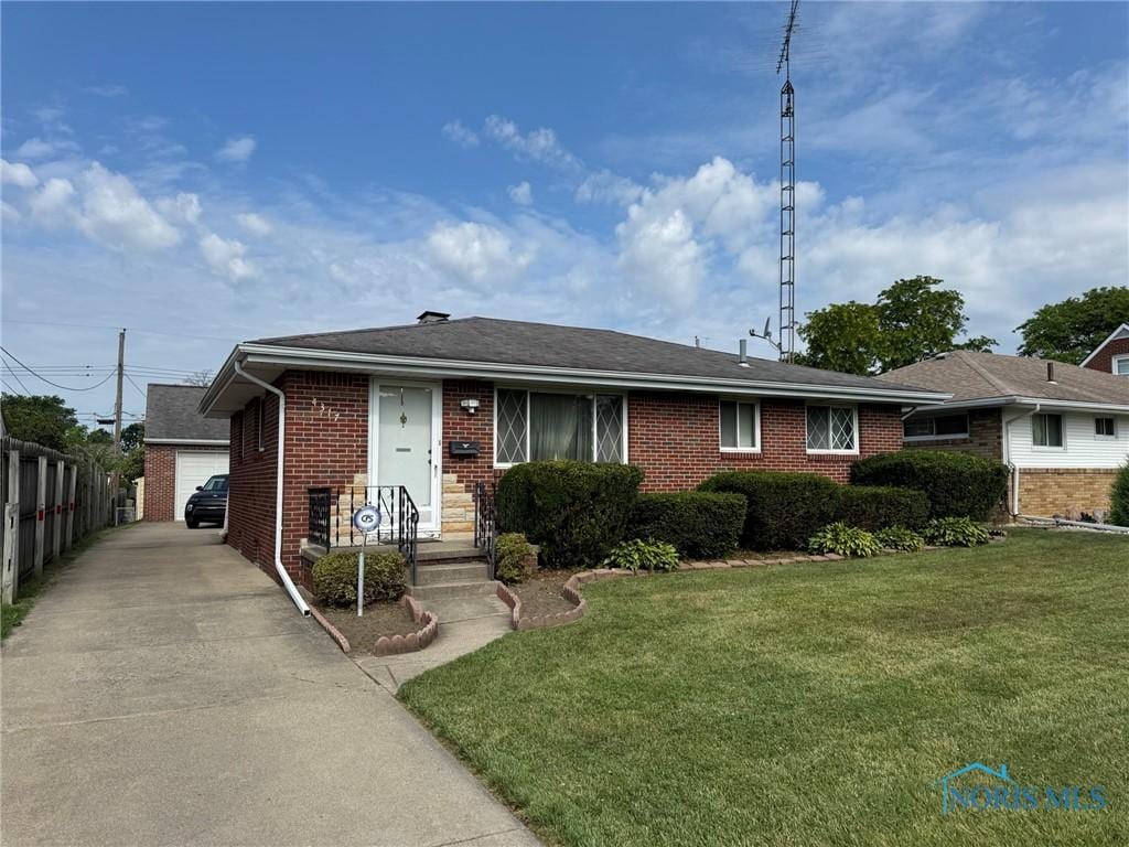 4317 290th St, Toledo, OH 43611 - ranch-style house featuring brick siding and a detached garage