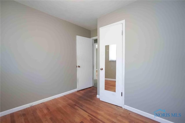 601 Edith Ave, Findlay, OH 45840 - unfurnished bedroom featuring wood finished floors and baseboards