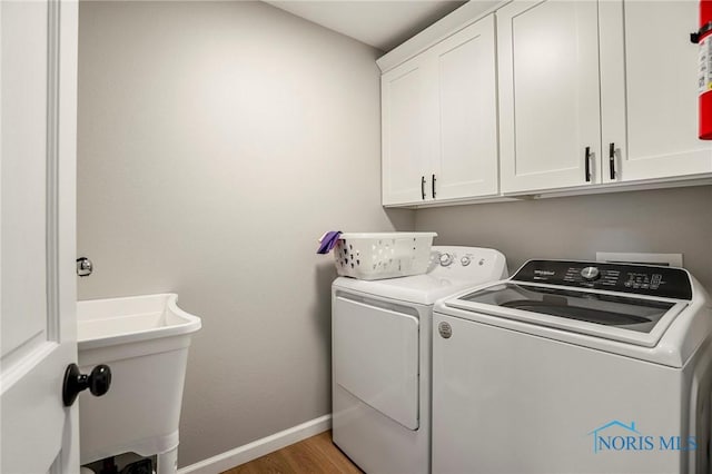2838 Long View Dr, Maumee, OH 43537 - washroom featuring separate washer and dryer, cabinet space, and light wood-type flooring