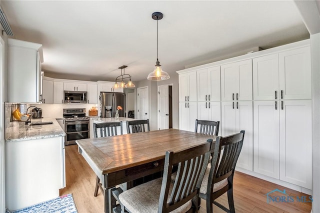 2838 Long View Dr, Maumee, OH 43537 - dining space with light wood-type flooring and a chandelier