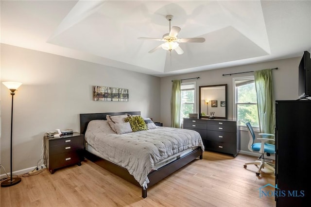 2838 Long View Dr, Maumee, OH 43537 - bedroom featuring a tray ceiling, light wood-type flooring, and ceiling fan
