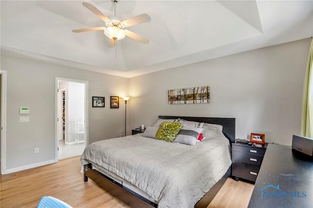 2838 Long View Dr, Maumee, OH 43537 - bedroom featuring light wood-style floors, a raised ceiling, and ceiling fan