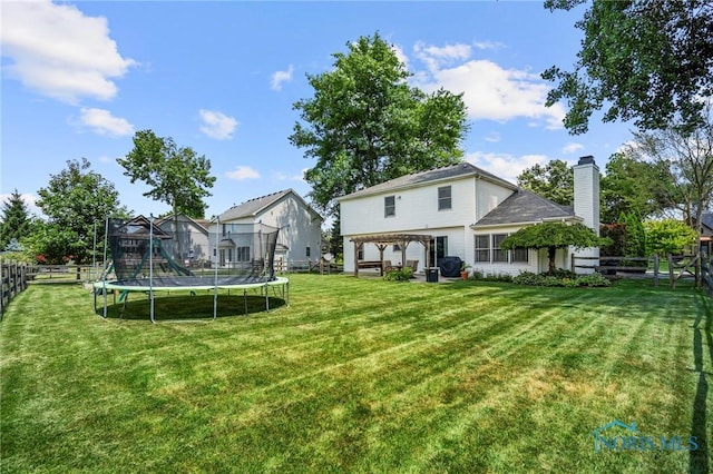 2838 Long View Dr, Maumee, OH 43537 - back of house featuring a trampoline, a chimney, a fenced backyard, and a pergola