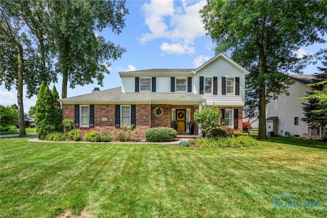2838 Long View Dr, Maumee, OH 43537 - traditional-style home with brick siding and a front yard