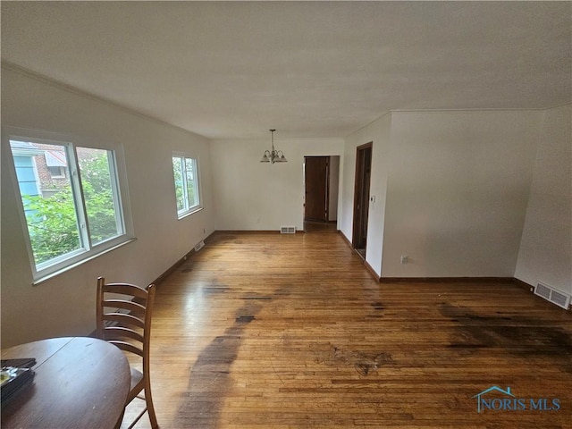 2916 Upton Ave, Toledo, OH 43606 - unfurnished dining area featuring hardwood / wood-style flooring and a chandelier
