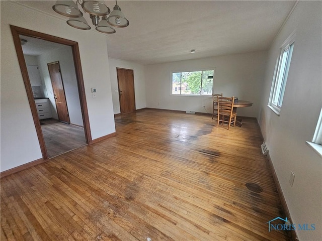 2916 Upton Ave, Toledo, OH 43606 - unfurnished dining area featuring a chandelier and hardwood / wood-style floors