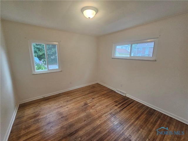 2916 Upton Ave, Toledo, OH 43606 - unfurnished room featuring plenty of natural light, hardwood / wood-style floors, and crown molding