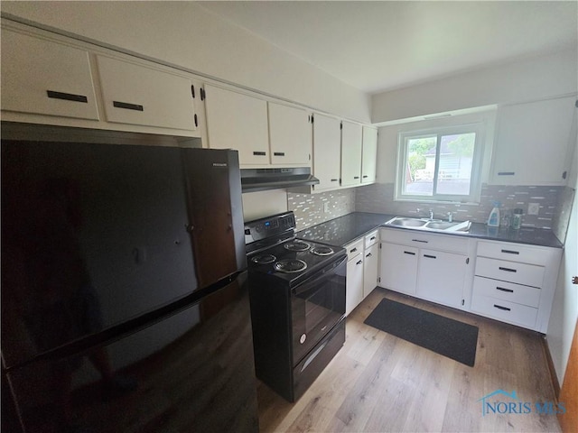 2916 Upton Ave, Toledo, OH 43606 - kitchen featuring freestanding refrigerator, electric range, under cabinet range hood, light wood finished floors, and backsplash