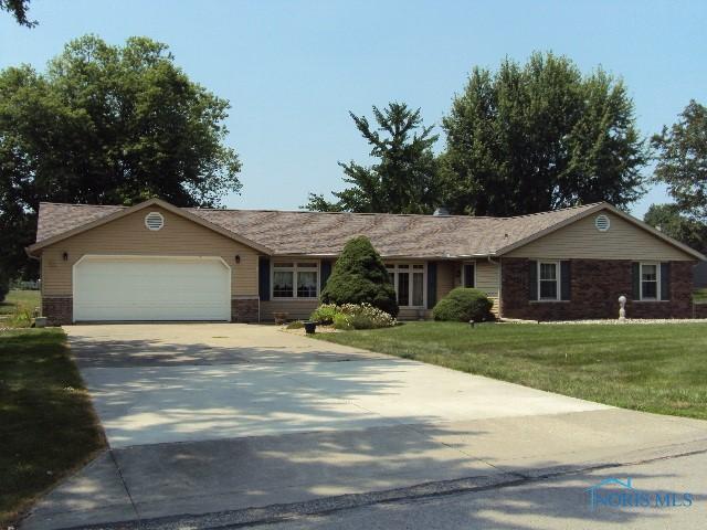 217 Lakeview Dr, Bryan, OH 43506 - ranch-style home featuring driveway, an attached garage, and a front lawn