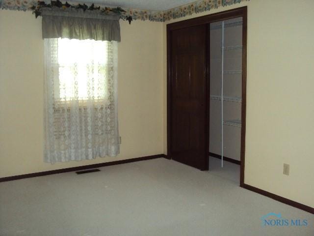 217 Lakeview Dr, Bryan, OH 43506 - unfurnished bedroom featuring a closet and carpet floors