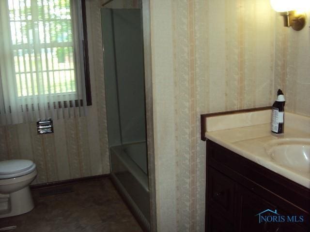 217 Lakeview Dr, Bryan, OH 43506 - bathroom featuring vanity, washtub / shower combination, and wallpapered walls