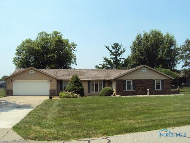 217 Lakeview Dr, Bryan, OH 43506 - ranch-style home with a garage, driveway, and a front lawn
