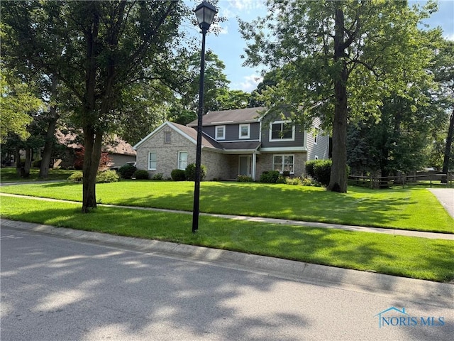 9151 Rolling Hill Rd, Holland, OH 43528 - view of front of home featuring a front lawn and brick siding
