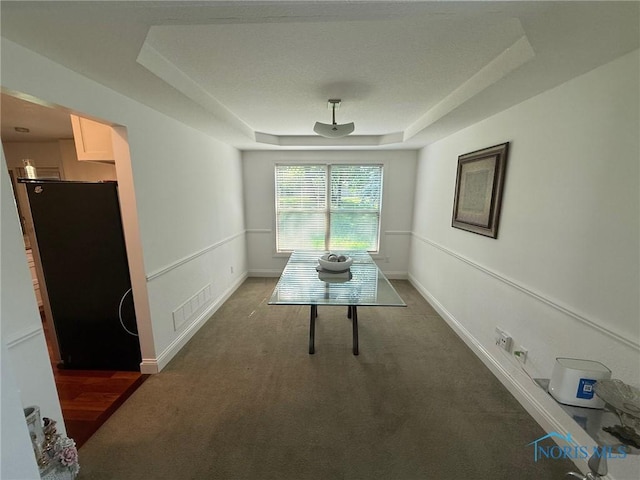 9151 Rolling Hill Rd, Holland, OH 43528 - carpeted dining room featuring a tray ceiling and baseboards