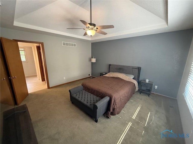 9151 Rolling Hill Rd, Holland, OH 43528 - bedroom featuring a tray ceiling, carpet floors, and ceiling fan