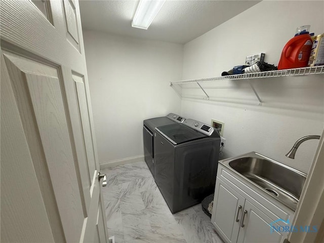 9151 Rolling Hill Rd, Holland, OH 43528 - laundry area featuring light marble finish flooring, cabinet space, and independent washer and dryer