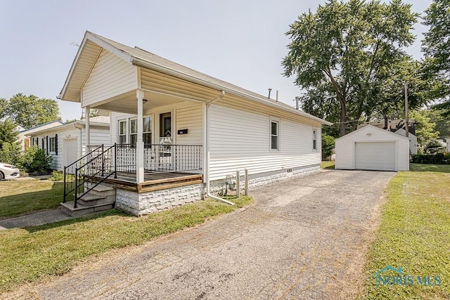 1333 Abbott Ave, Toledo, OH 43614 - view of front of house featuring covered porch, an outdoor structure, a garage, a front yard, and asphalt driveway