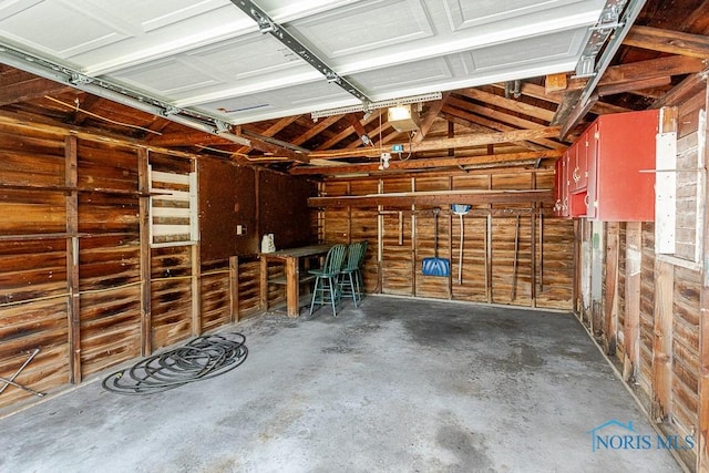 1333 Abbott Ave, Toledo, OH 43614 - garage featuring wooden walls and a garage door opener