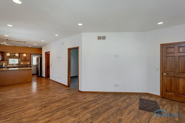 1333 Abbott Ave, Toledo, OH 43614 - unfurnished living room featuring dark wood-type flooring and recessed lighting