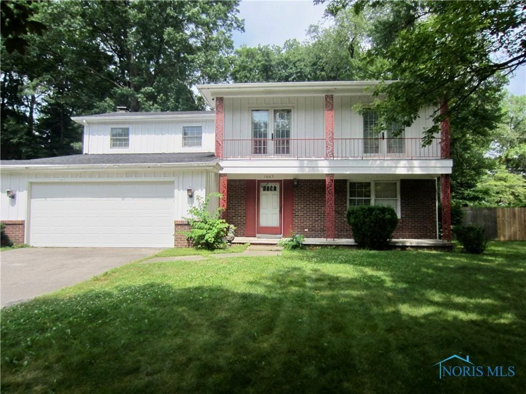 1665 Fallbrook Rd, Toledo, OH 43614 - view of front of home featuring board and batten siding, brick siding, concrete driveway, and a porch