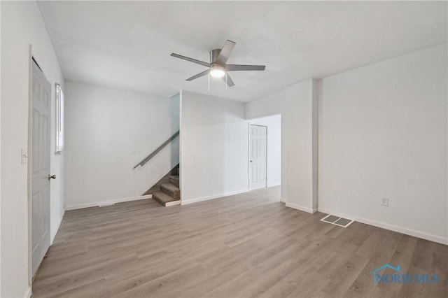 1155 Pinewood Ave, Toledo, OH 43607 - spare room with stairway, ceiling fan, and wood finished floors