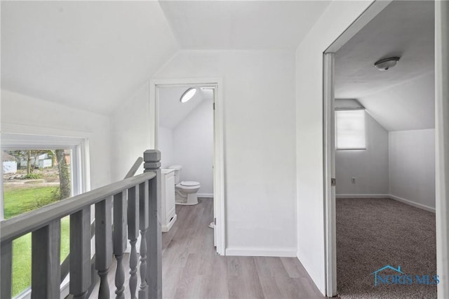 1155 Pinewood Ave, Toledo, OH 43607 - hall featuring vaulted ceiling, an upstairs landing, plenty of natural light, and wood finished floors