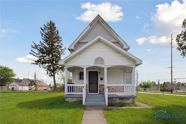 1155 Pinewood Ave, Toledo, OH 43607 - view of front of house with a porch and a front yard