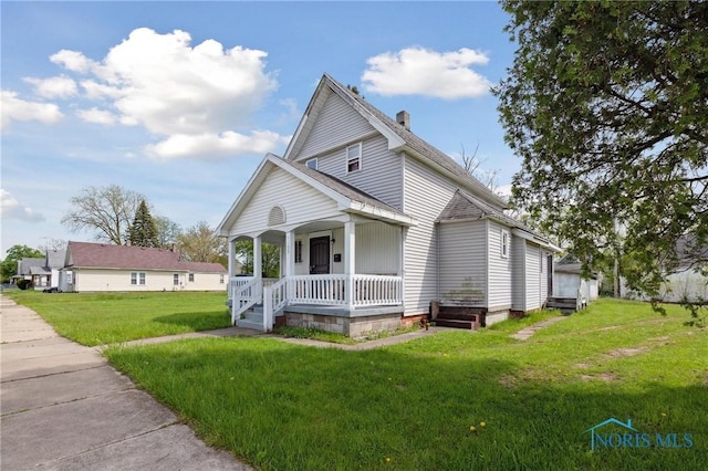 1155 Pinewood Ave, Toledo, OH 43607 - view of front of property with a porch, a front lawn, and a chimney