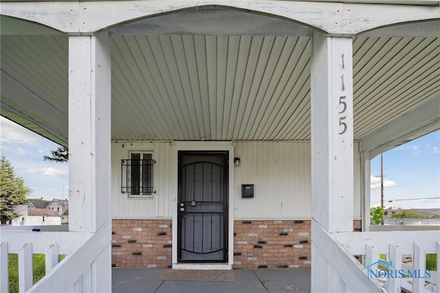 1155 Pinewood Ave, Toledo, OH 43607 - view of exterior entry featuring brick siding and covered porch